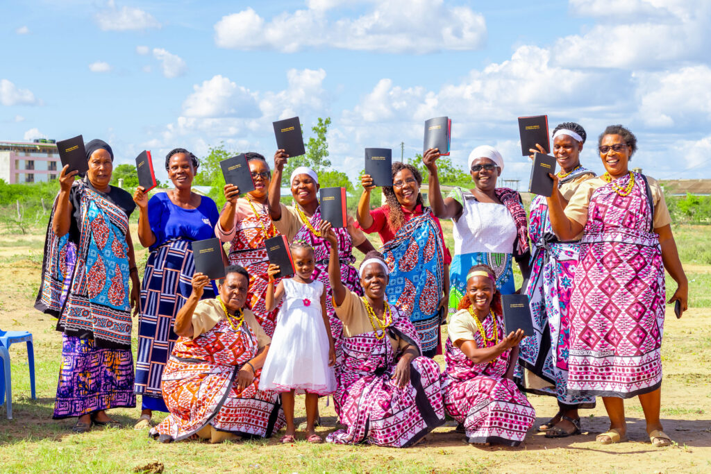 Kenyan women joyfully holding Bibles
