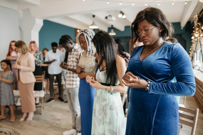 A diverse congregation praying together in a serene indoor environment representing unity and faith.
